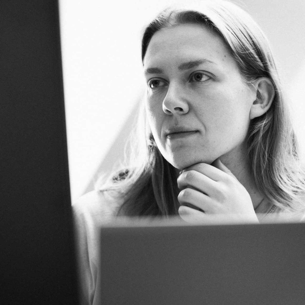 Woman looking at computer screen at a powerpoint presentation